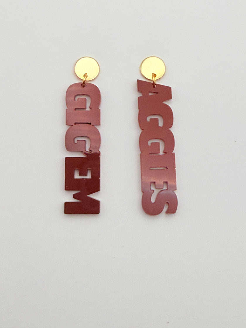 Metallic 'AGGIES' and 'GIG'EM' letters on a light gray background