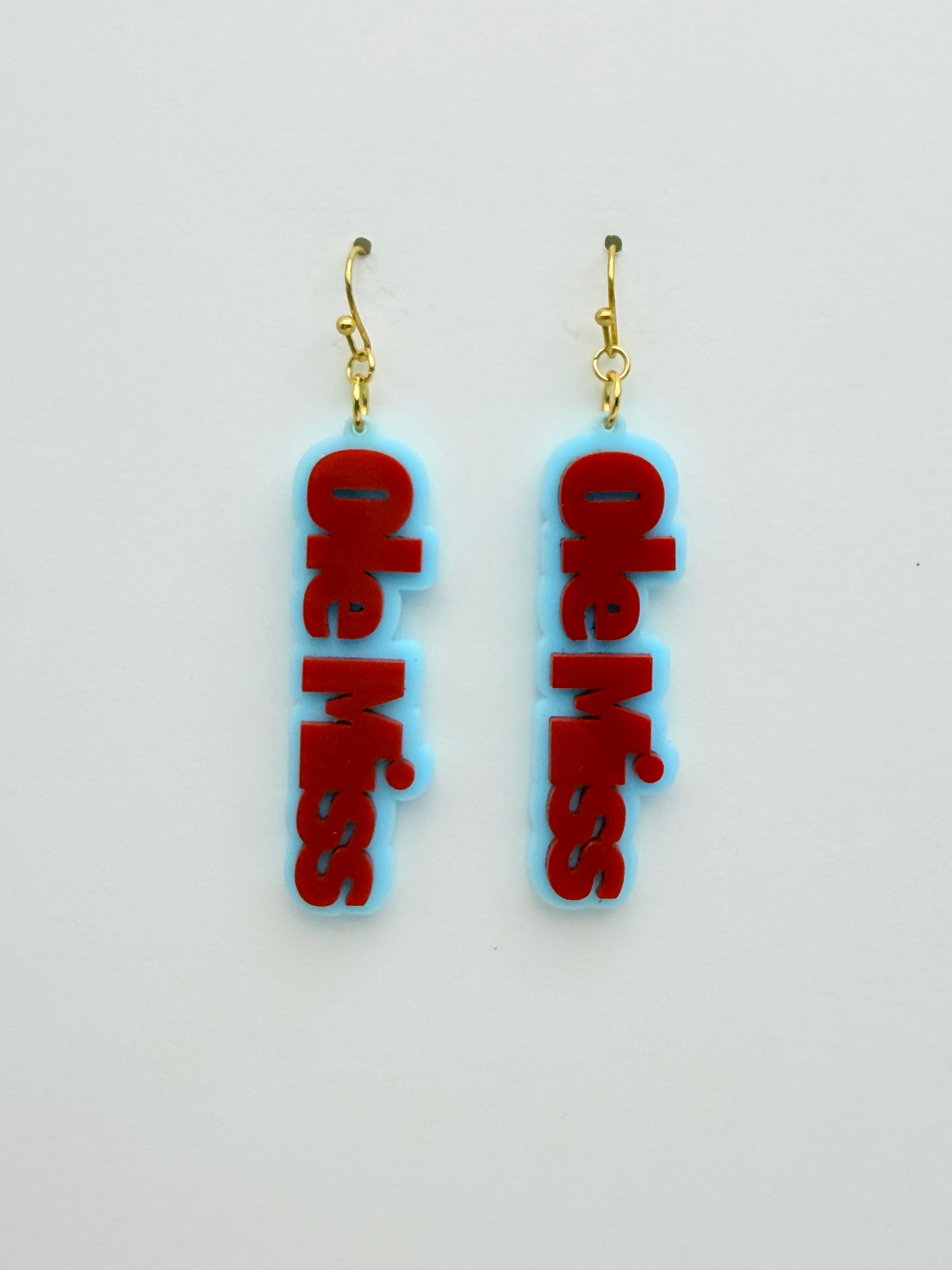 Ole Miss earrings with red text on a light gray background