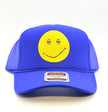 A royal blue trucker hat with a yellow smiley face patch on the front, set against a plain white background.