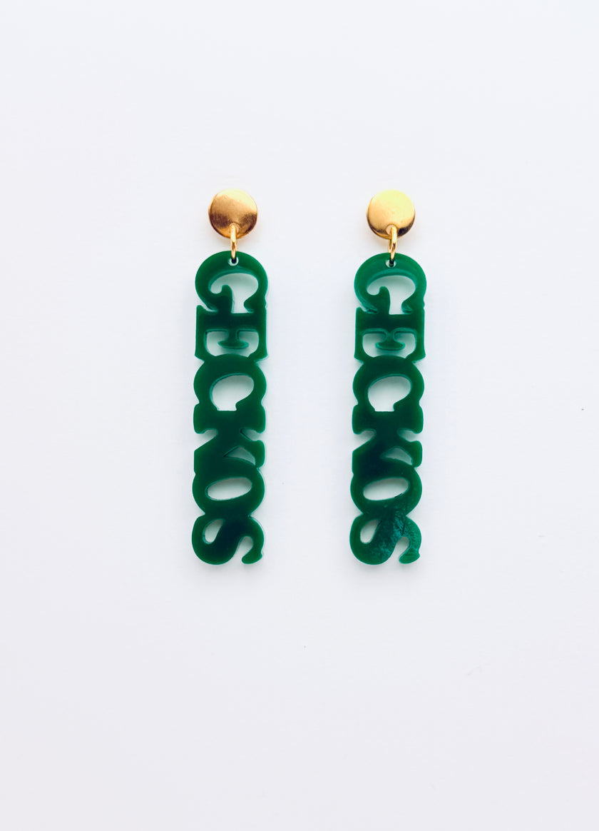 Green earrings with gold tops on a white background