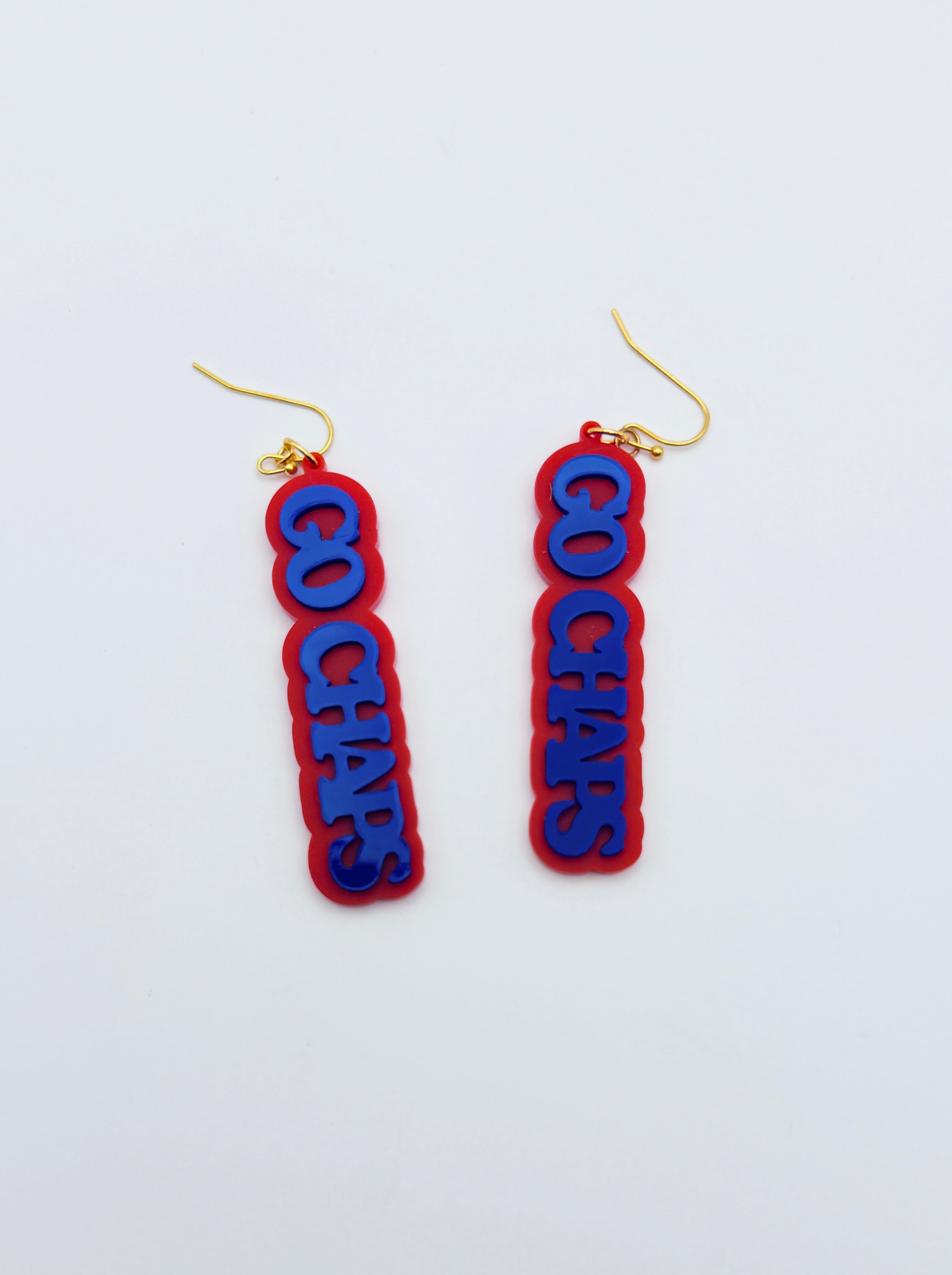Red and blue earrings with 'GO CHAPS' text on a white background