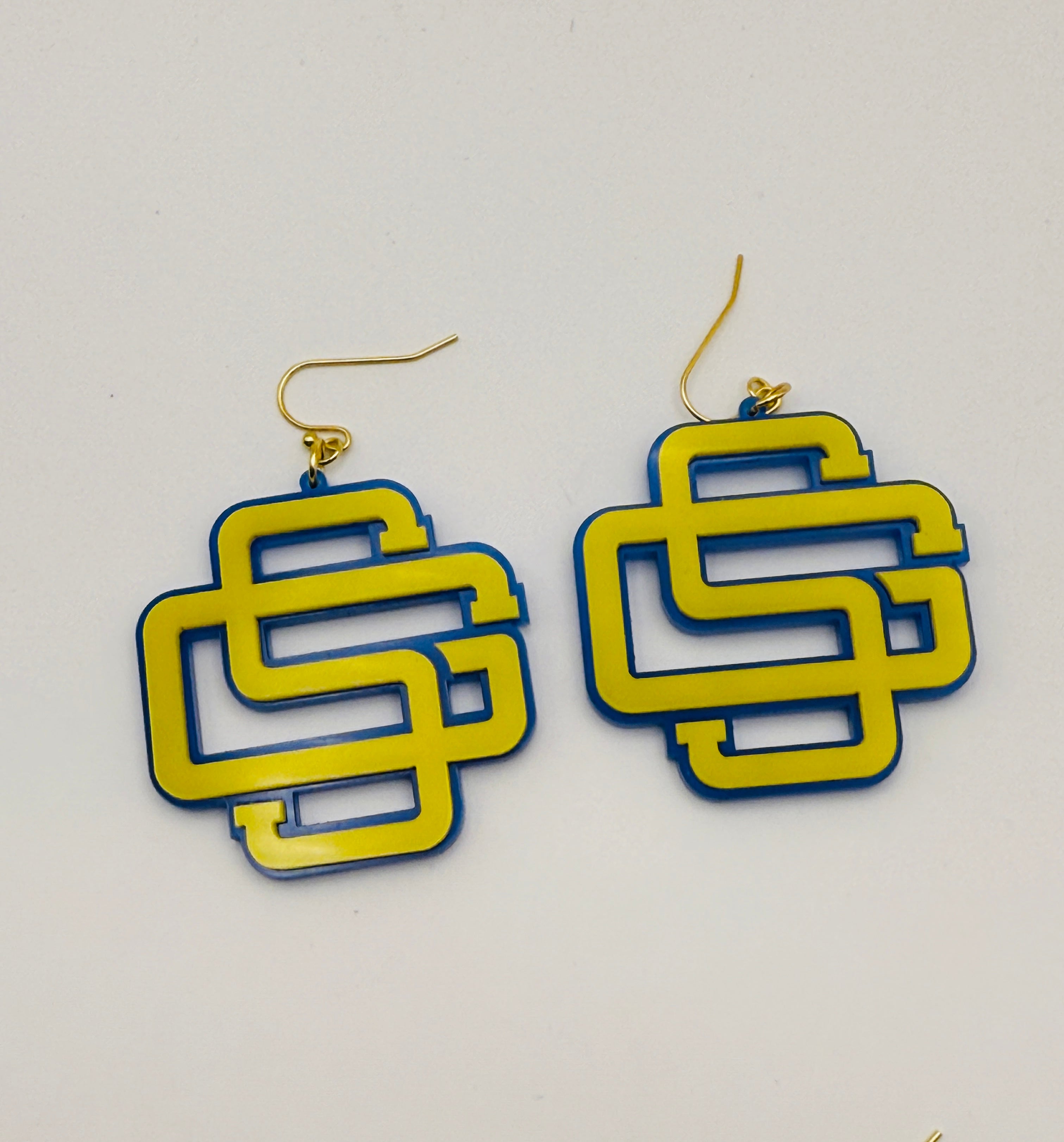 Pair of yellow and blue geometric earrings on a white background