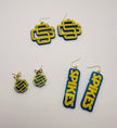 Pair of blue and yellow earrings on a white background