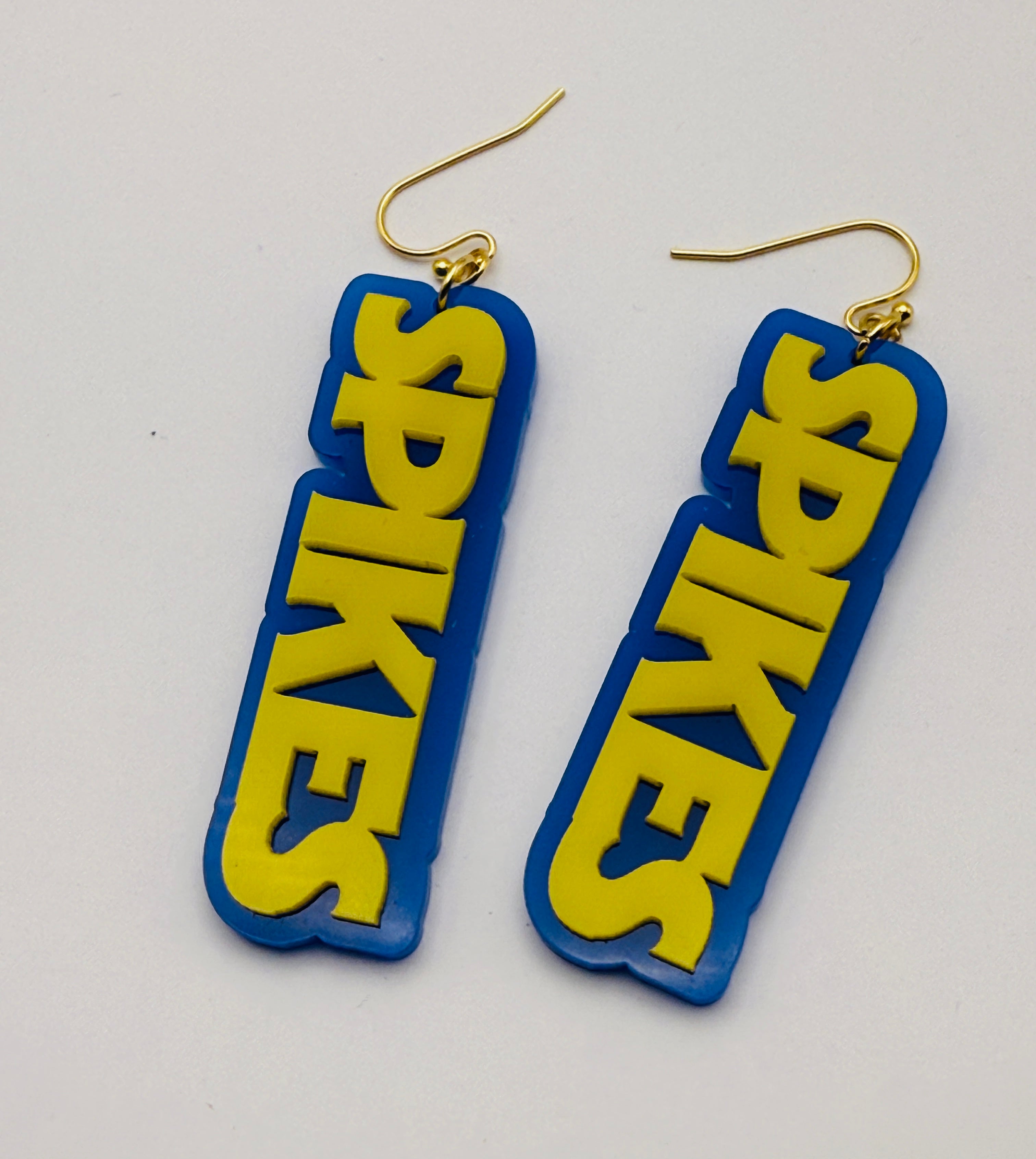 Blue and yellow 'Spikes' earrings on a white background