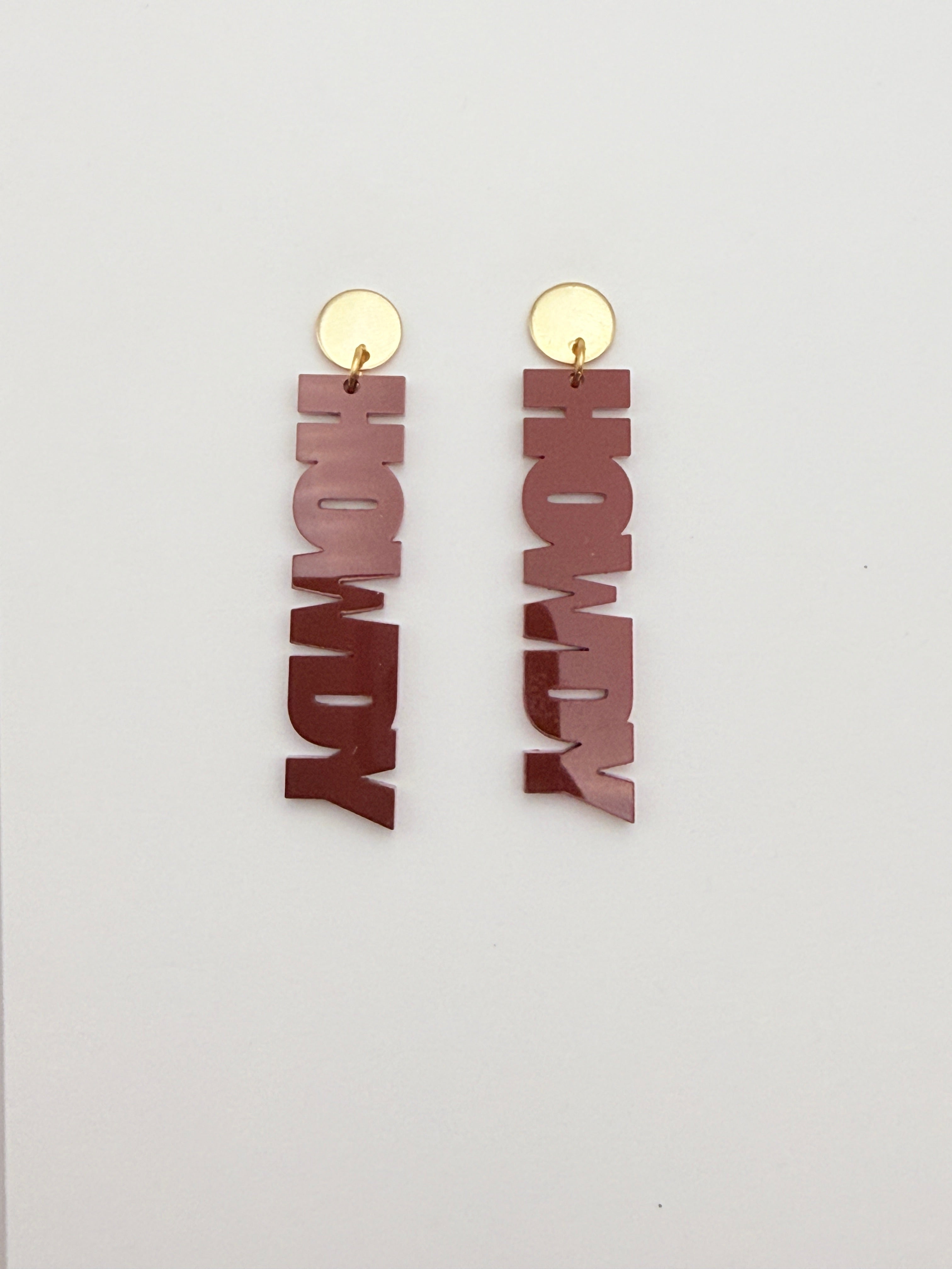 Wooden 'HOWDY' earrings with gold hooks on a white background