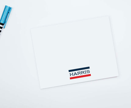 A flat notecard with a personalized name and address on it, displaying a blank front and a printed back with 'CAMP OTX' and a logo.