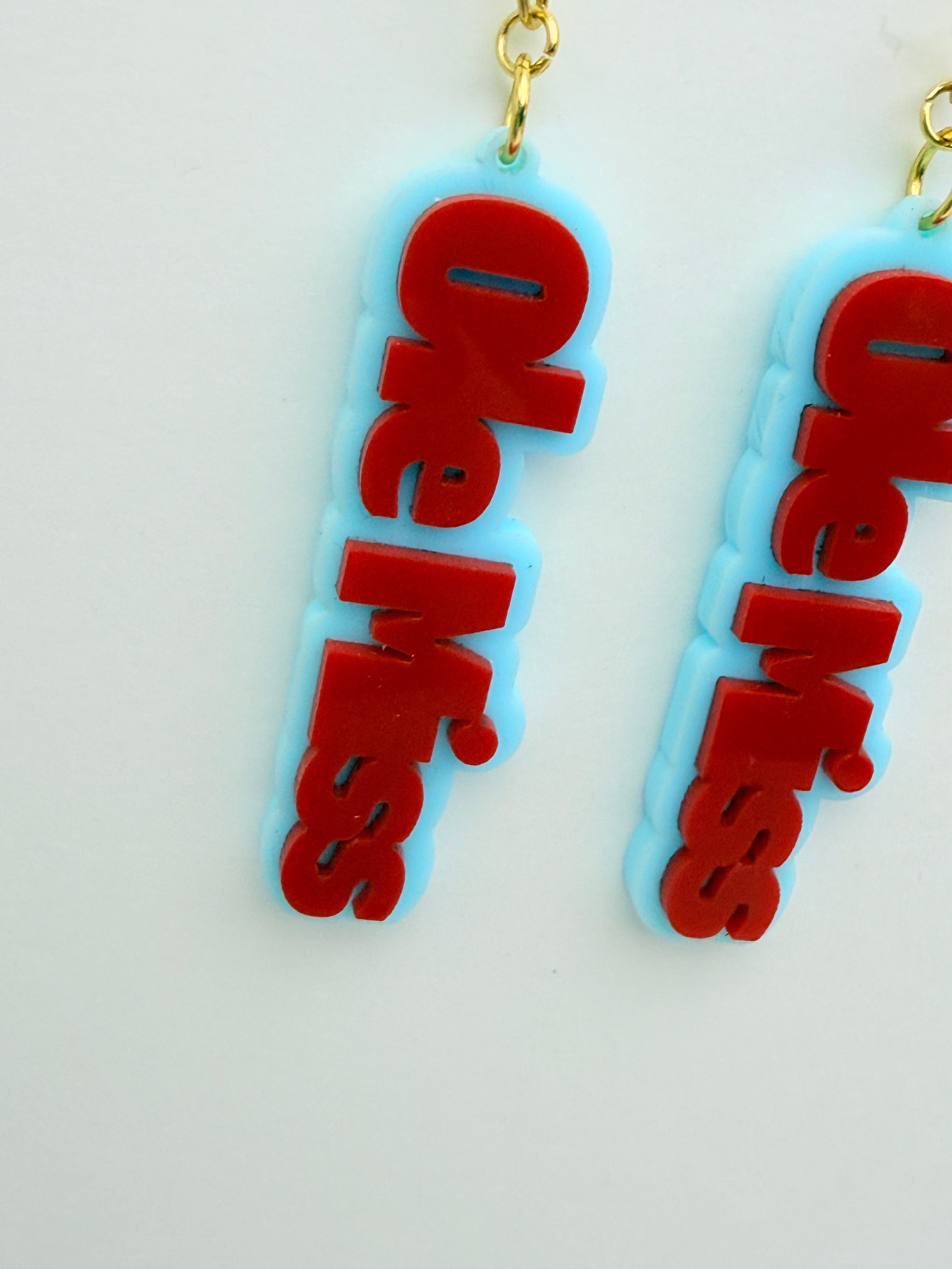 Two 'Ole Miss' earrings on a light gray background