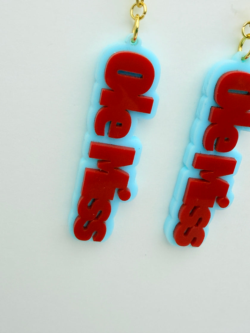 Two 'Ole Miss' earrings on a light gray background