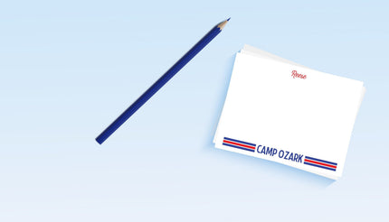 A set of personalized camp stationery with 'Camp Ozark' stripes, including notecards and a pencil, displayed on a light background.