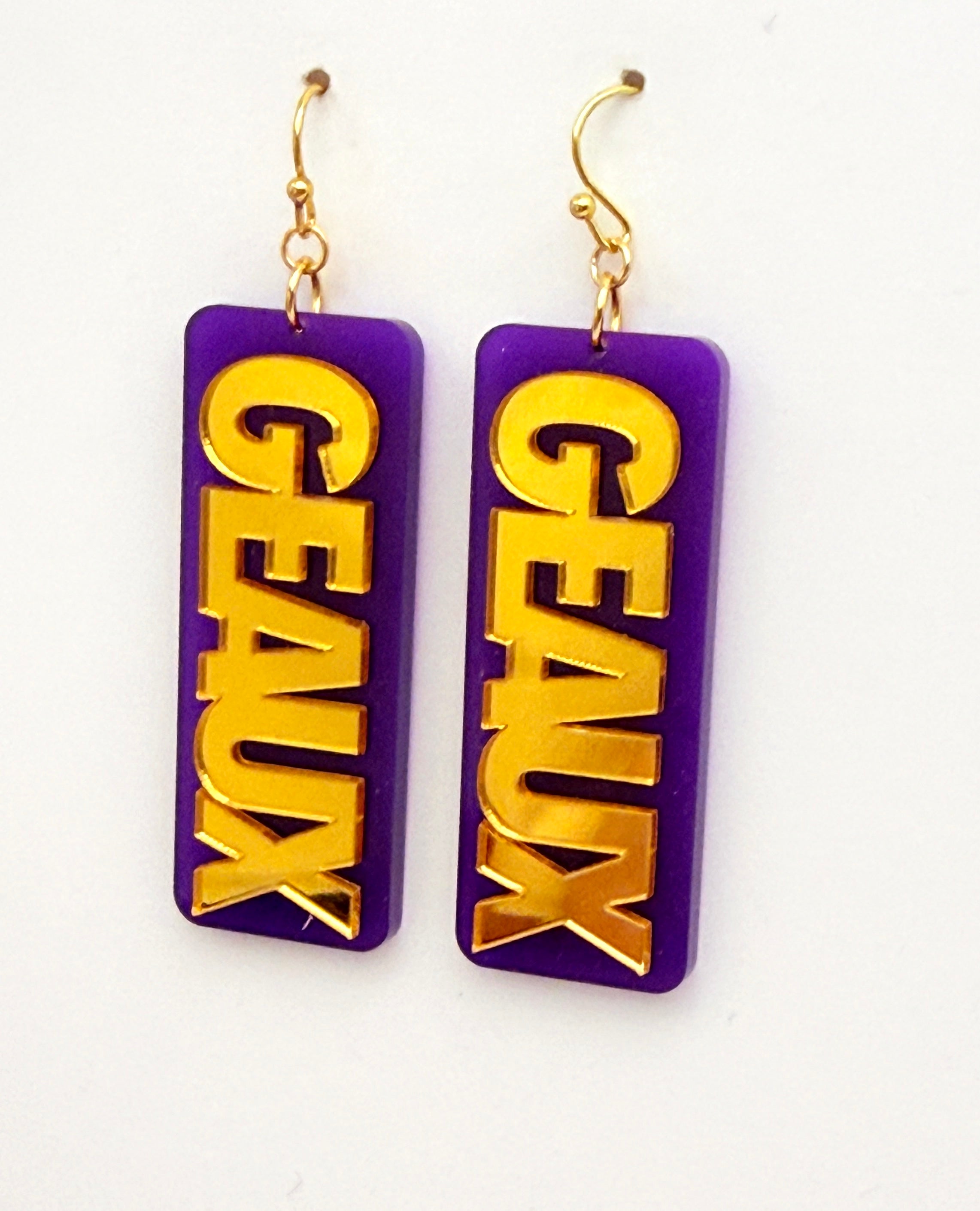 Purple and gold earrings with 'GEaux' text on a white background
