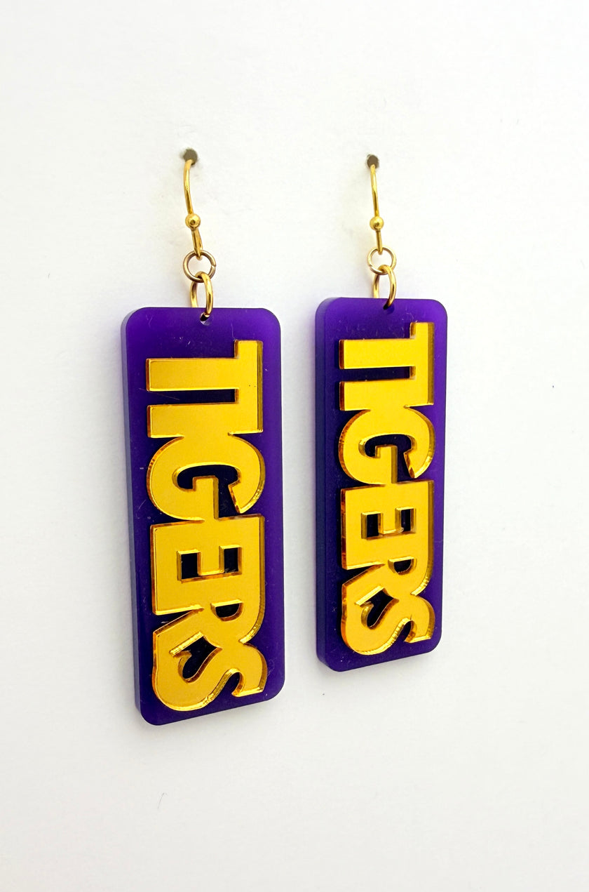 Purple and gold 'TIGERS' earrings on a white background