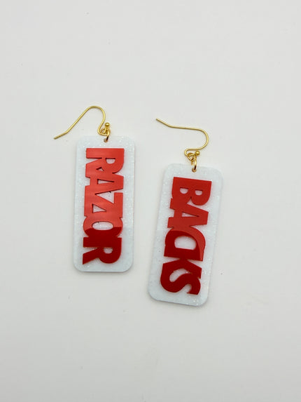 Two earrings with 'BACKS' and 'RAZOR' text on a light gray background
