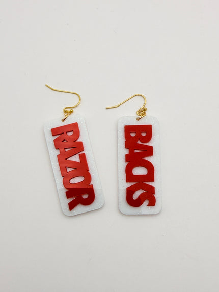Pair of earrings with 'BACKS' and 'RAZOR' text on a white background
