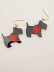 Black and red dog-shaped earrings on a light gray background