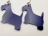 Purple dog-shaped earrings on a white background