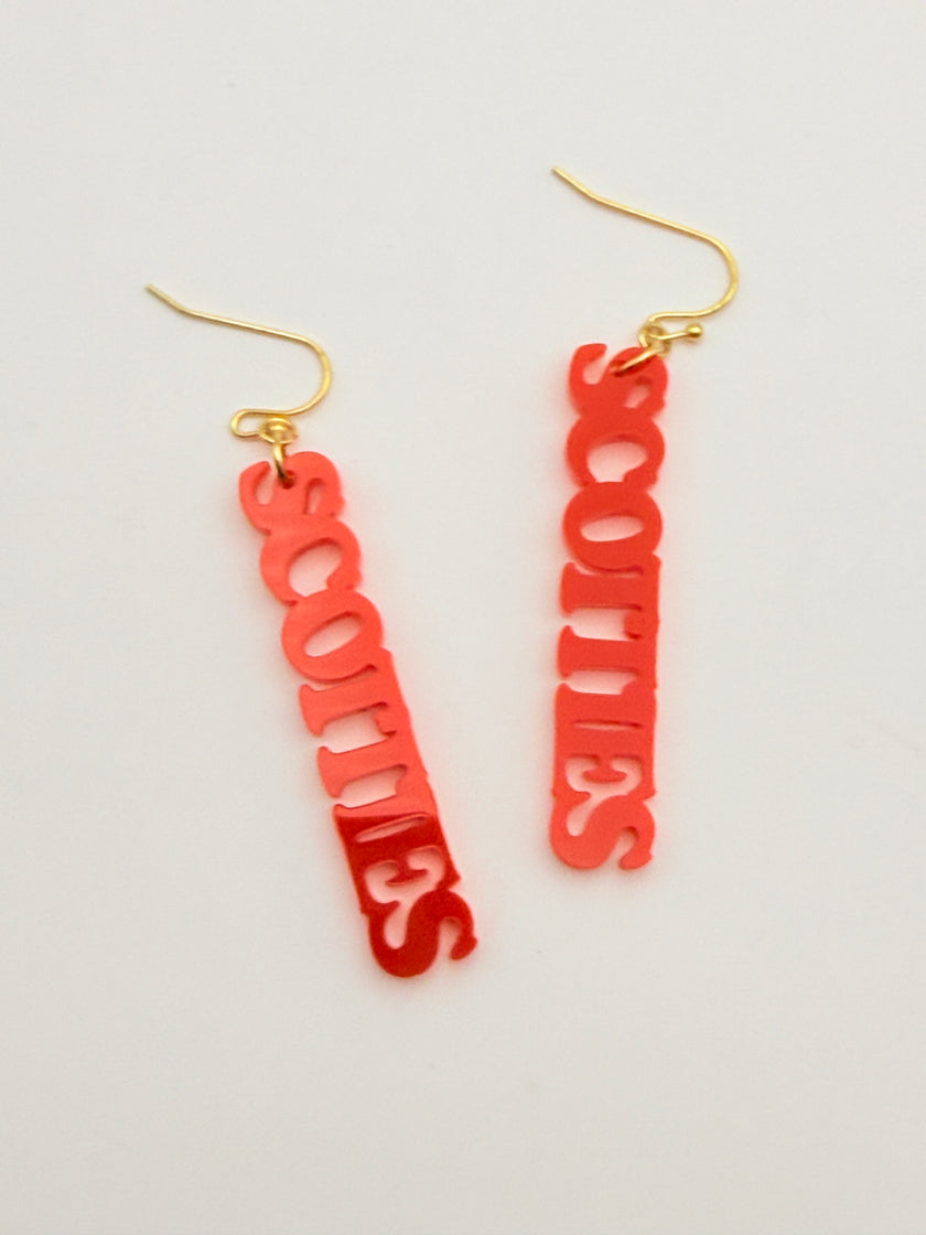Red 'SCOTTIES' earrings on a light gray background