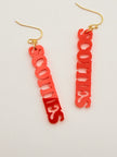 Red 'SCOTTIES' earrings on a light gray background