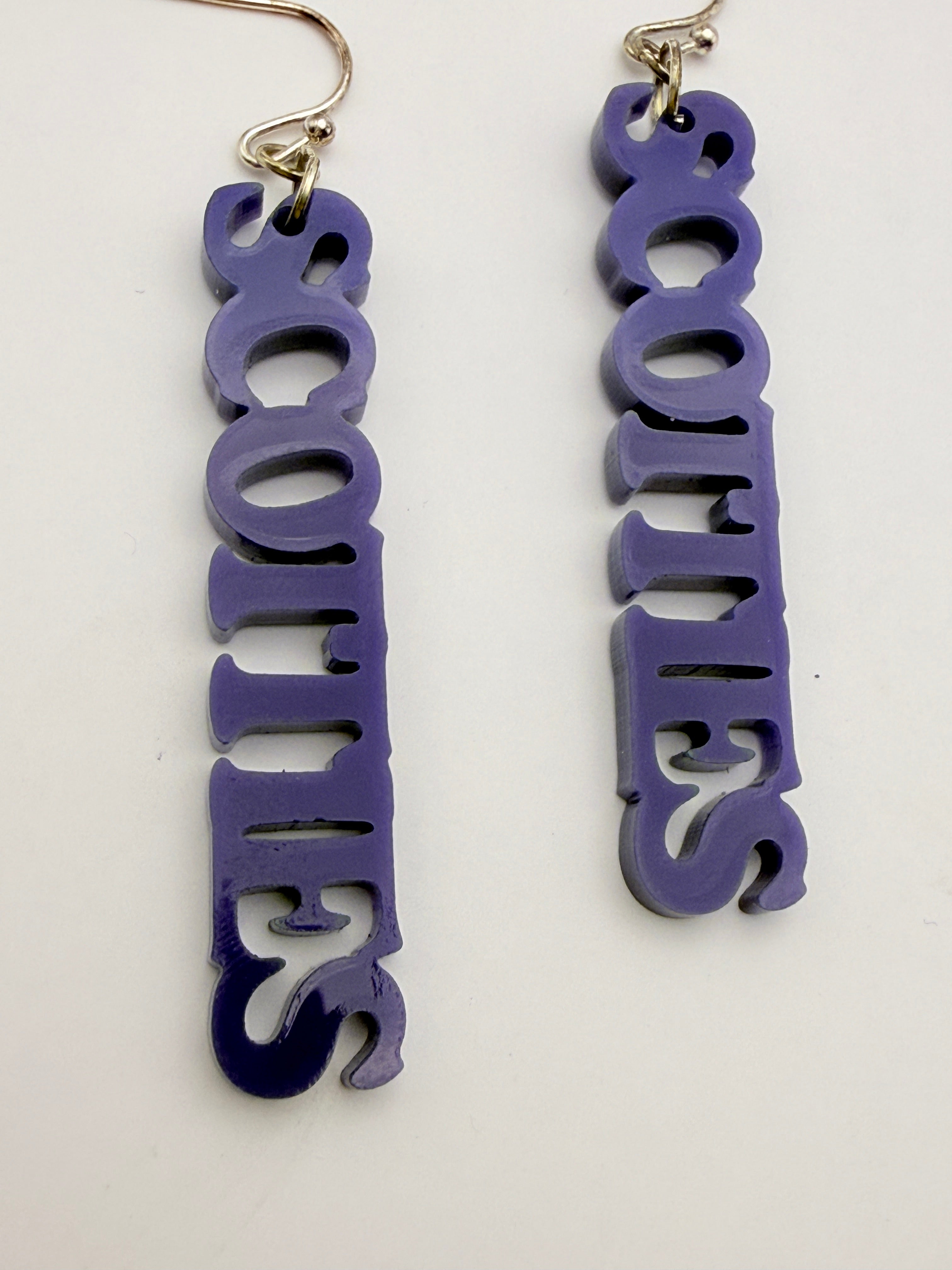 Purple 'SCOTTIES' earrings on a white background