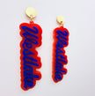 Red and blue 'Westlake' earrings on a white background