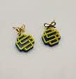 Pair of earrings with blue and yellow geometric design on a white background