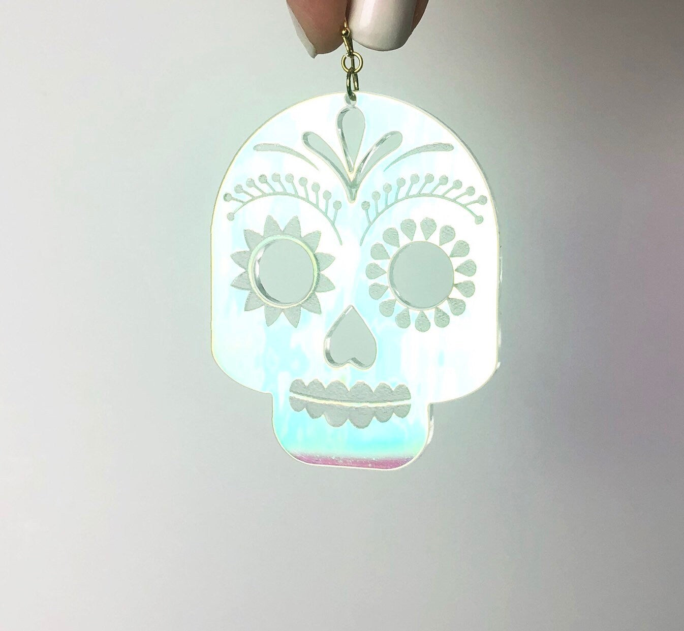 Glowing skull-shaped pendant on a gray background