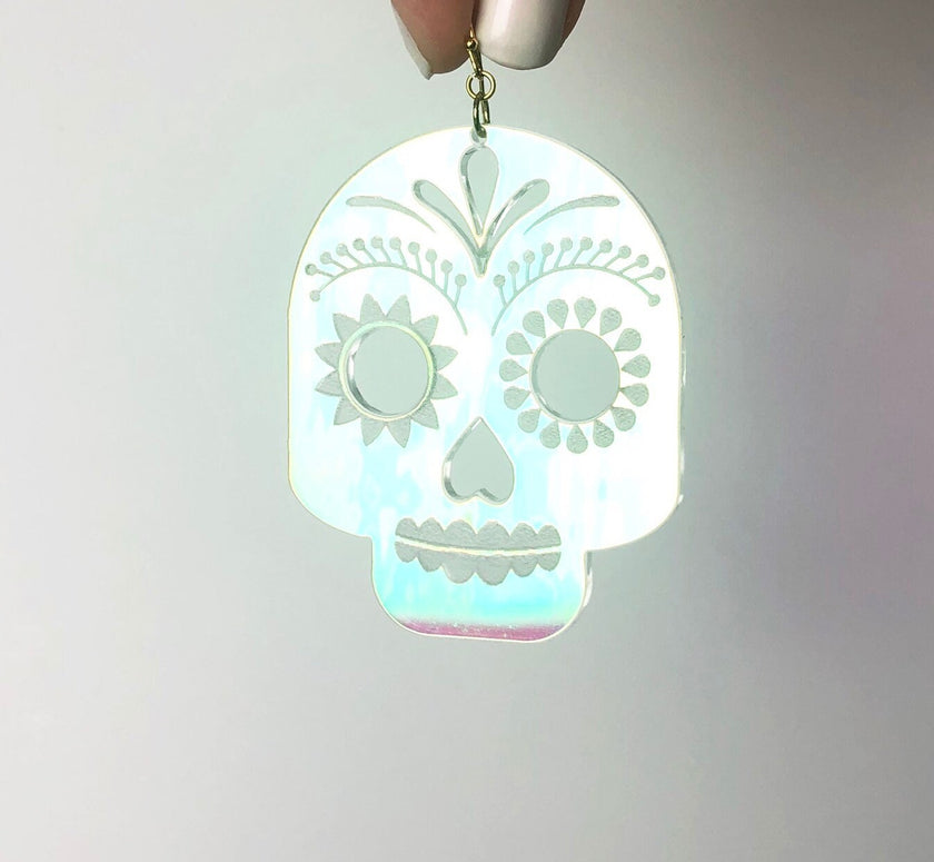 Glowing skull-shaped pendant on a gray background