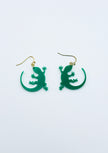 Green lizard-shaped earrings on a white background