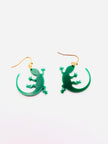 Green lizard-shaped earrings on a white background