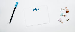 A set of personalized note cards with a Texas monogram design, along with envelopes and a pen, displayed on a white background.