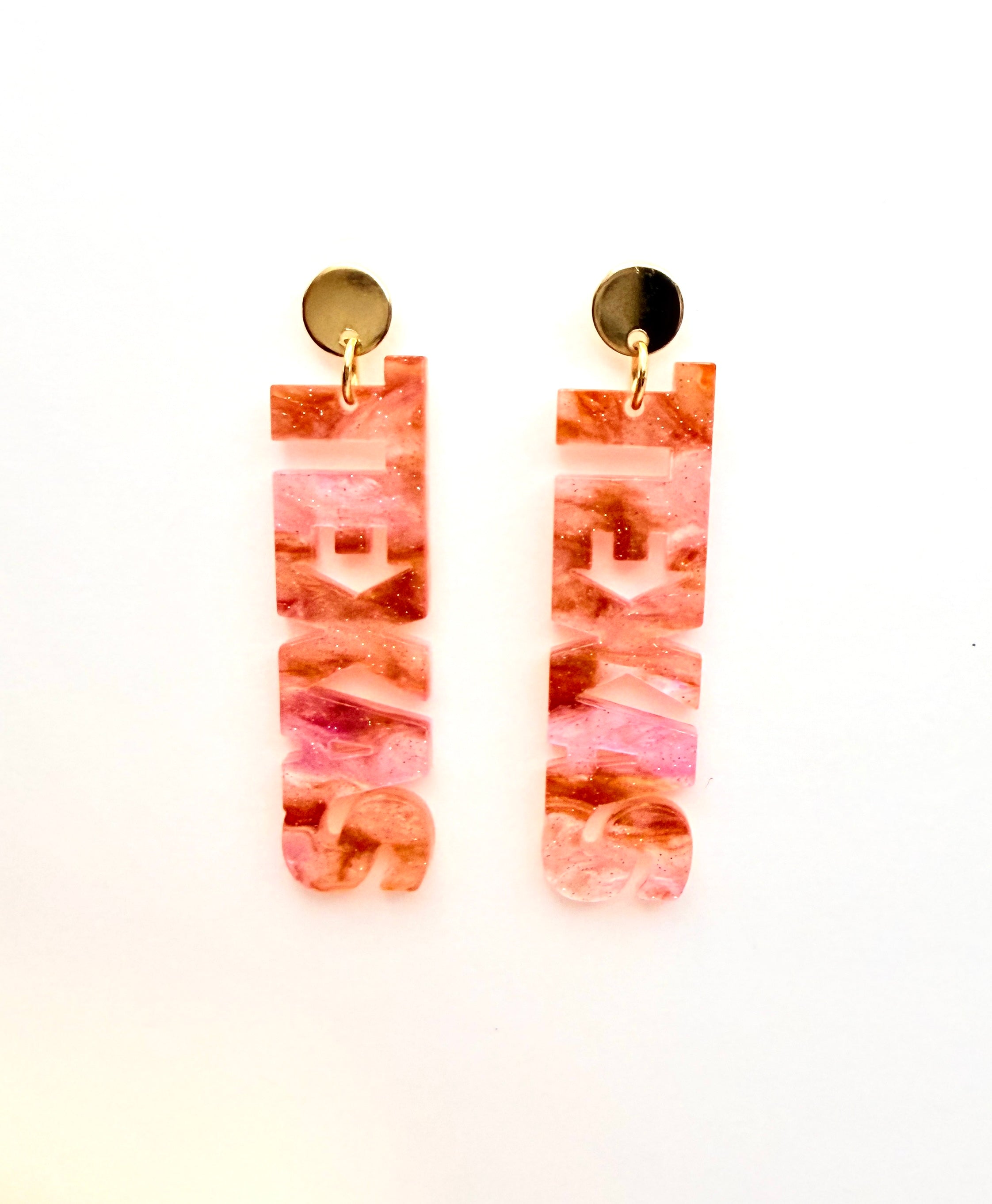 Pair of pink marbled earrings on a white background