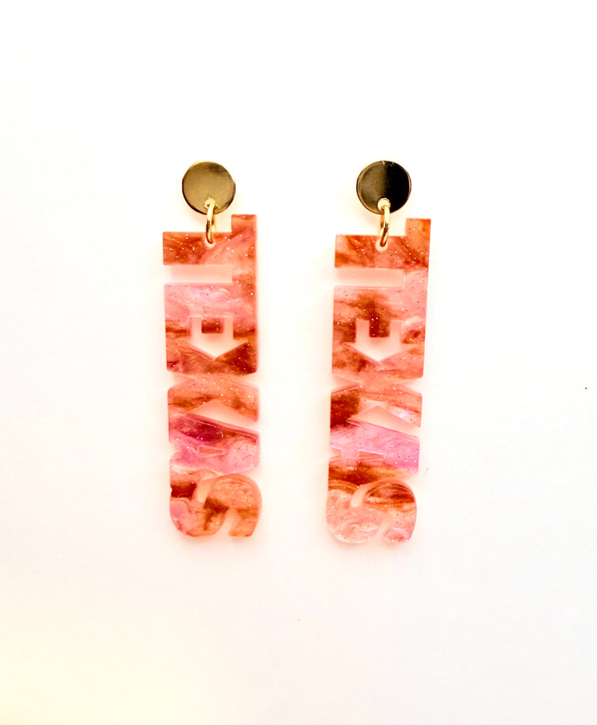 Pair of pink marbled earrings on a white background