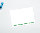 A flat notecard with a green and white border, personalized with the name 'Aztec' in the center, and a blank back.
